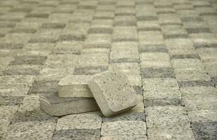 Small pile of gray walkway slabs lying in stack outdoors. Material for Paving Slabs by mosaic in progress. Cobblestone installation photo