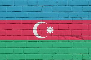 Azerbaijan flag depicted in paint colors on old brick wall. Textured banner on big brick wall masonry background photo