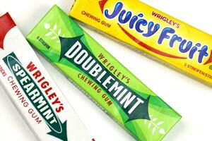 KHARKOV, UKRAINE - FEBRUARY 14, 2021 Wrigleys Spearmint Doublemint and Juicy Fruit chewing gum in classic design photo