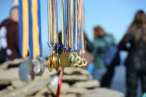 CARPATHIAN MOUNTAINS, UKRAINE - OCTOBER 8, 2022 Trade of medals on the top of Hoverla mountain in Carpathians photo