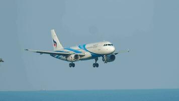 PHUKET, THAILAND DECEMBER 3, 2018 Side view, Aircraft Airbus A320 of Bangkok Air approaching landing at Phuket airport. Airplane flies. Passenger flight arriving video