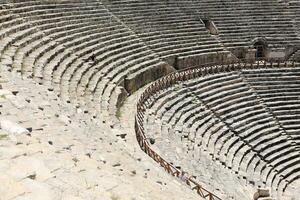 ANTALYA, TURKEY - MAY 15, 2021 Ruins of amphitheatre in ancient city Hierapolis near Pamukkale, Turkey at sunny day. Parts of old historical buildings with big blocks photo