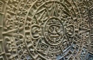 Ancient Mayan Calendar or Aztec calendar with rough relief surface photo