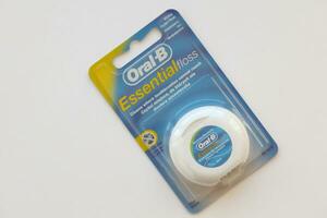 KYIV, UKRAINE - JULY 7, 2023 Oral-B Essentail Floss. Waxed dental floss in round case photo