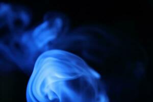 Blue smoke on a dark background, blue wave photo