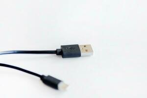 Black USB charging cable, compatible for many devices, isolated on white background. photo