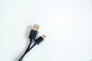 Black USB charging cable, compatible for many devices, isolated on white background. photo