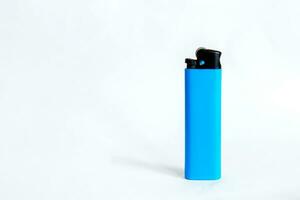 Blue plastic lighter on white background photo