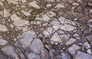 Background of shattered stony stones surface in mountain area. Texture with natural light photo
