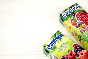 KHARKOV, UKRAINE - JULY 2, 2021 Sadochok Apple and grape nectar from red varieties and apple with pomegranate juice tetra-packs photo