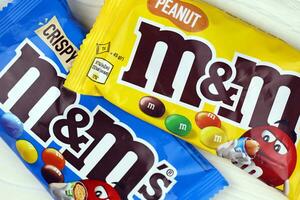 KHARKIV, UKRAINE - JANUARY 2, 2021 M and Ms colorful button shaped chocolate candies. Multi colored chocolates each of which has the letter m printed in lower case in white photo