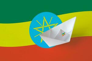 Ethiopia flag depicted on paper origami ship closeup. Handmade arts concept photo