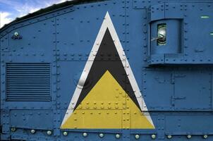 Saint Lucia flag depicted on side part of military armored tank closeup. Army forces conceptual background photo