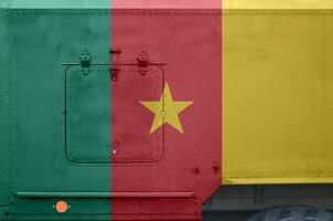 Cameroon flag depicted on side part of military armored truck closeup. Army forces conceptual background photo