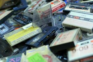 KYIV, UKRAINE - 4 MAY, 2023 Pile of audio cassettes lying on top of each other. Retro audio storage photo