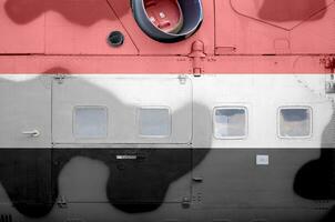 Yemen flag depicted on side part of military armored helicopter closeup. Army forces aircraft conceptual background photo