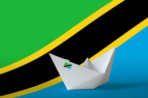 Tanzania flag depicted on paper origami ship closeup. Handmade arts concept photo