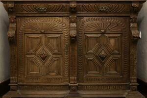 Old vintage wardrobe furniture with ornamental doors and retro colors of wooden surfaces photo