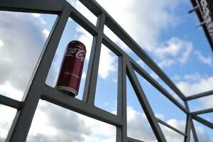KYIV, UKRAINE - 4 MAY, 2023 Coca cola soft drink brand tin can with cherry flavour photo