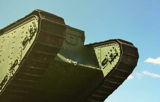 Caterpillars of the green British tank of the Russian Army Wrangel in Kharkov against the blue sky photo