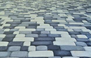 A detailed photo of the square, laid out of modern paving stone with rounded corners. Accurate design of pedestrian areas