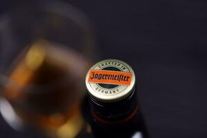 KHARKOV, UKRAINE - DECEMBER 3, 2020 Jagermeister cold macerated elixir bottle on dark black background. Elite alcohol photo