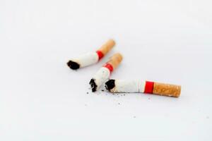 Three cigarette butts on a white background photo