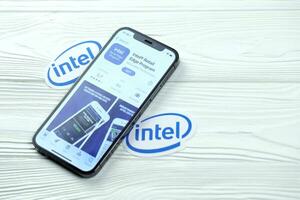 KHARKOV, UKRAINE - MARCH 5, 2021 Intel icon and application from App store on iPhone 12 pro display screen on white table photo