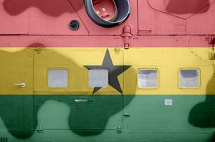 Ghana flag depicted on side part of military armored helicopter closeup. Army forces aircraft conceptual background photo