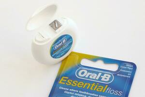 KYIV, UKRAINE - JULY 7, 2023 Oral-B Essentail Floss. Waxed dental floss in round case photo