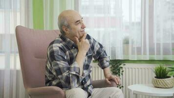 Depressed thoughtful old man by the window. video