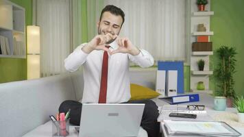 Happy and positive young businessman makes heart symbol. video