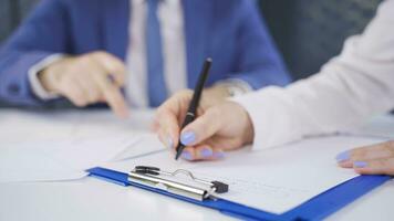 Close-up hands of woman taking notes and male employee reviewing project. video