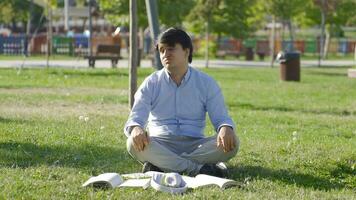 University student who is bored with studying is sitting outdoors in the park. video