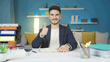 Home office worker looking at camera and making positive gesture. video