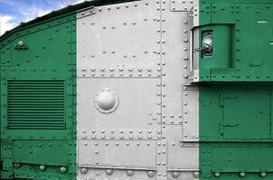 Nigeria flag depicted on side part of military armored tank closeup. Army forces conceptual background photo