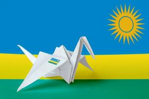 Rwanda flag depicted on paper origami crane wing. Handmade arts concept photo