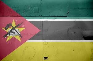 Mozambique flag depicted on side part of military armored helicopter closeup. Army forces aircraft conceptual background photo