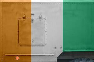 Ivory Coast flag depicted on side part of military armored truck closeup. Army forces conceptual background photo