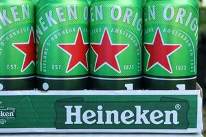 KHARKOV, UKRAINE - JULY 31, 2021 Green tin cans of Heineken lager beer produced by the Dutch brewing company Heineken N.V. photo