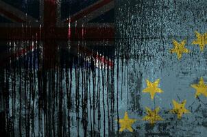 Tuvalu flag depicted in paint colors on old and dirty oil barrel wall closeup. Textured banner on rough background photo