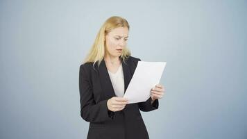 Business woman examines paperwork and gets upset. video