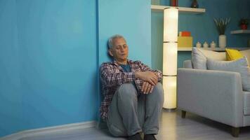 Depressed man. It sits by the wall. video