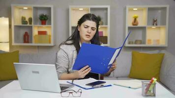 Home office worker woman looking at the file angrily. video