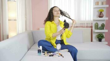 Young woman blow drying her hair. video