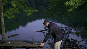 Businessman talking by phone in natural area. video