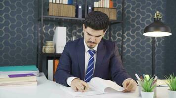 Businessman reading paperwork. video