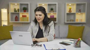 Home office worker woman rejoices at what she sees on the laptop. video