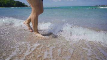Feet walking on the beach. video