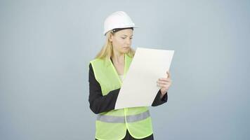 The engineer examines the project in her hands. video